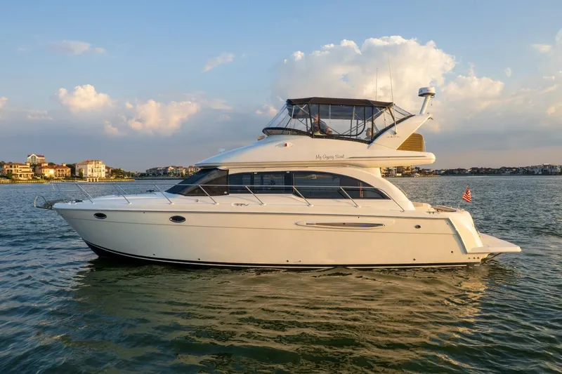 Slide: The Image of 2004 Meridian 411 Sedan yacht cruising on calm waters at sunset. - 47