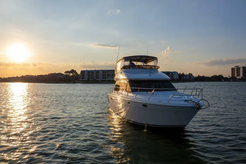 Slide: The Image of 2004 Meridian 411 Sedan yacht on serene water at sunset. - 49