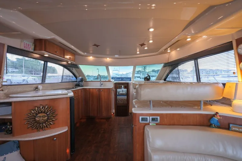 Slide: The Image of Luxurious interior of a 2004 Meridian 411 Sedan yacht with wood accents and plush seating. - 8