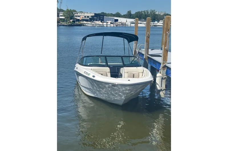 Slide: The Image of 2024 Monterey M-20 boat docked on calm water with a canopy. - 12