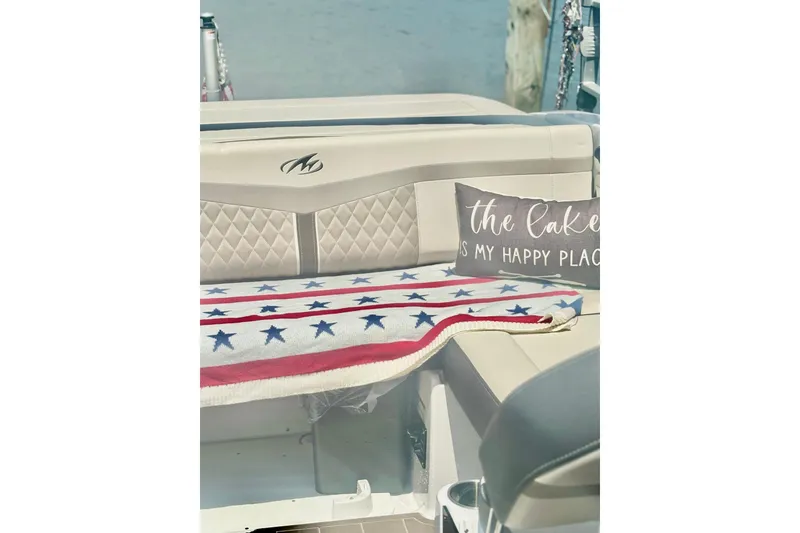 Slide: The Image of 2024 Monterey M-20 boat interior with star-patterned blanket and decorative pillow. - 7