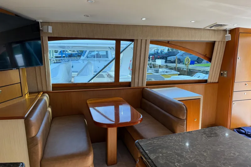 Slide: The Image of Interior of 2005 Ocean Yachts 46 Super Sport with dining area and large windows. - 13