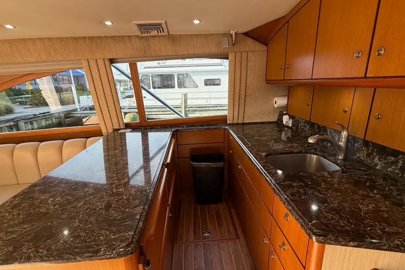 Slide: The Image of Luxurious 2005 Ocean Yachts 46 Super Sport galley with marble countertops and wood cabinetry. - 15