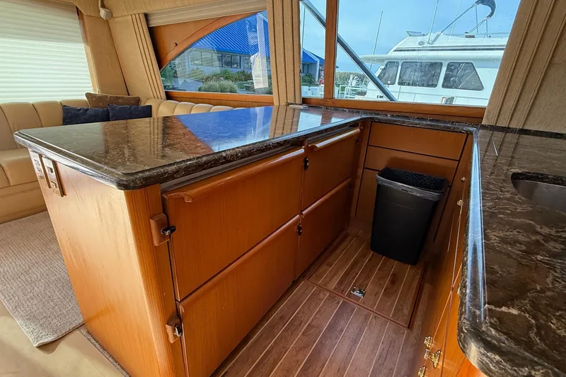 Slide: The Image of Luxurious interior of 2005 Ocean Yachts 46 Super Sport with wood cabinetry and granite countertops. - 16