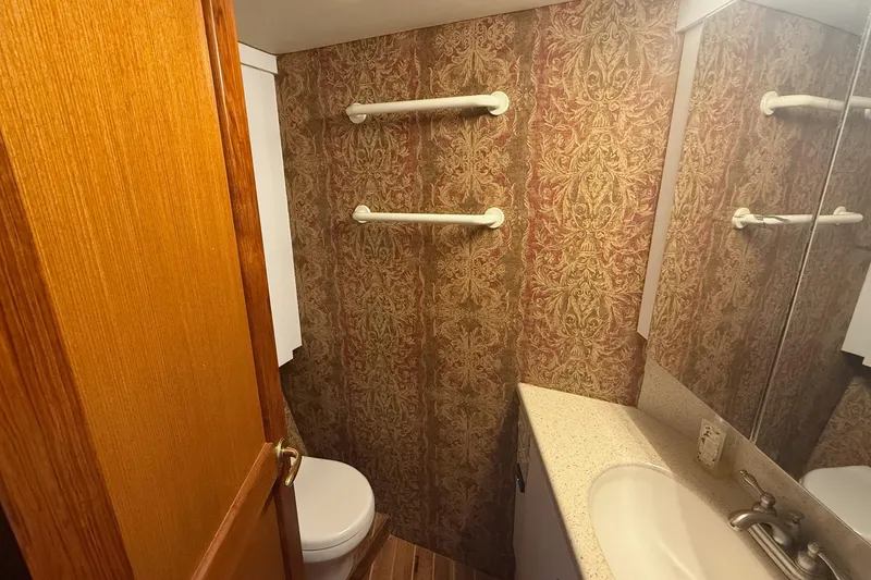 Slide: The Image of Bathroom interior of 2005 Ocean Yachts 46 Super Sport with ornate wallpaper and countertop sink. - 21