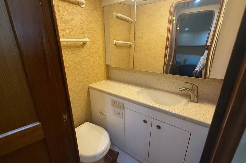 Slide: The Image of Bathroom interior of 2005 Ocean Yachts 46 Super Sport, featuring sink and toilet. - 22