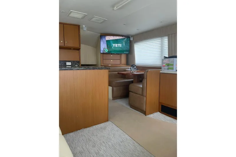 Slide: The Image of Interior of 2005 Ocean Yachts 46 Super Sport with cozy dining area and TV. - 24