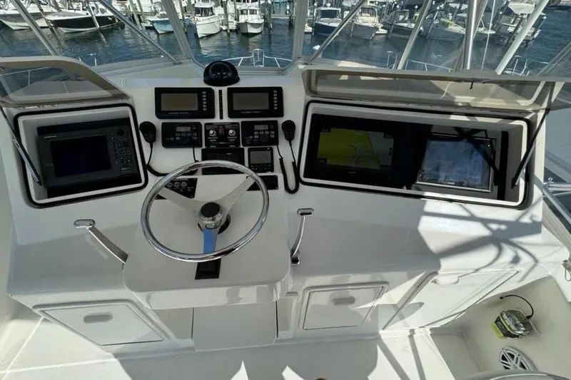 Slide: The Image of 2005 Ocean Yachts 46 Super Sport boat deck at marina, featuring spacious seating and storage. - 7