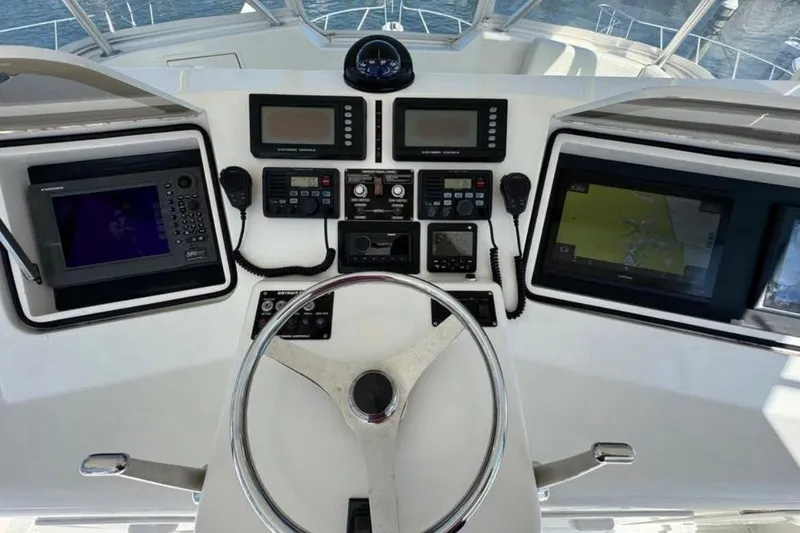Slide: The Image of Cockpit of 2005 Ocean Yachts 46 Super Sport with navigation equipment and steering wheel. - 8