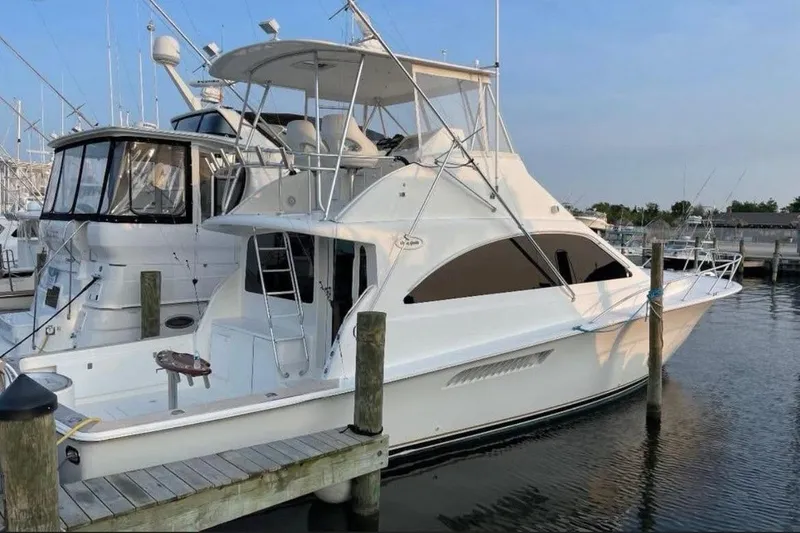 Slide: The Image of 2005 Ocean Yachts 46 Super Sport docked at marina under blue sky. - 1