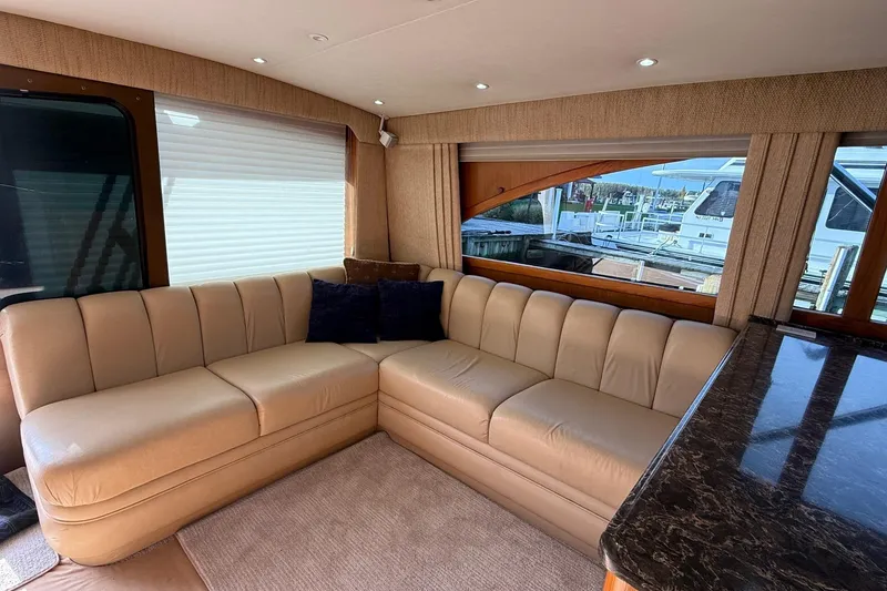 Slide: The Image of Luxurious interior of 2005 Ocean Yachts 46 Super Sport with beige leather seating and large windows. - 12