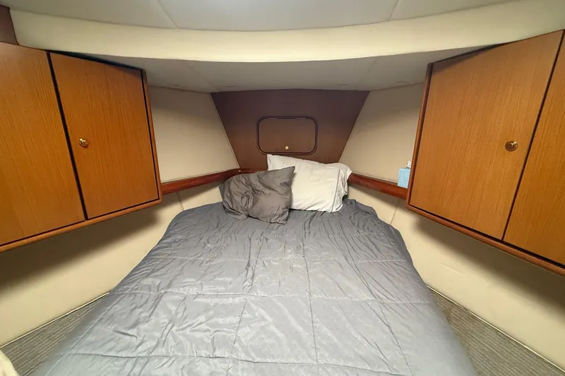 Slide: The Image of Cozy cabin interior of 2005 Ocean Yachts 46 Super Sport with bed and wooden cabinets. - 23