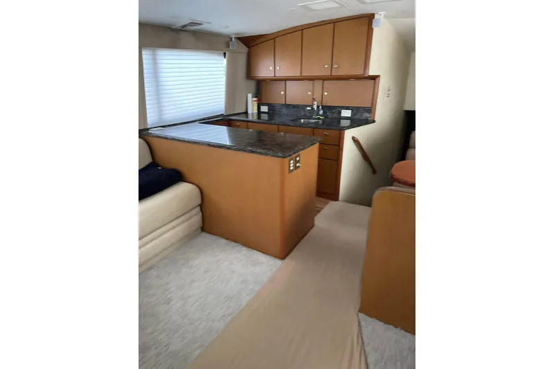 Slide: The Image of Interior of 2005 Ocean Yachts 46 Super Sport with modern kitchen and seating area. - 25