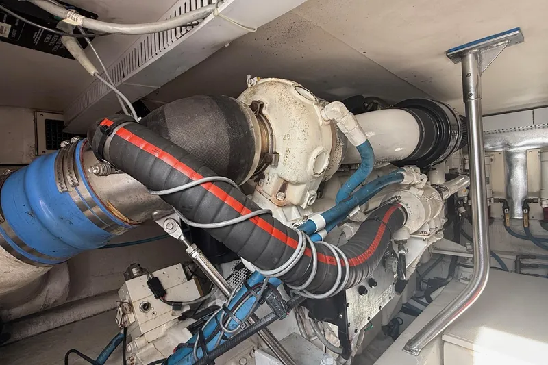 Slide: The Image of Engine room of 2005 Ocean Yachts 46 Super Sport, showcasing complex machinery and piping. - 28