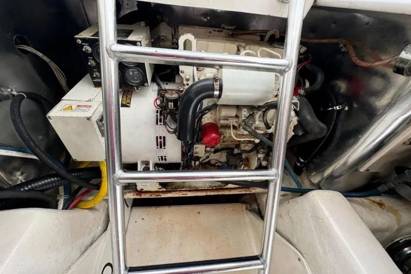 Slide: The Image of Engine room of 2005 Ocean Yachts 46 Super Sport with visible generator and ladder. - 30