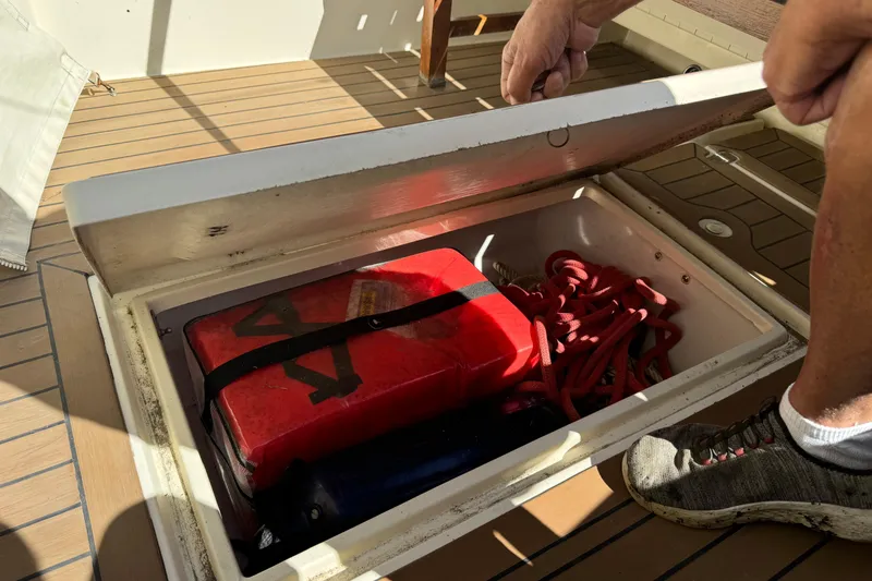 Slide: The Image of Boat storage compartment with red fuel container and coiled rope, Eastern 24, 2009 model. - 11