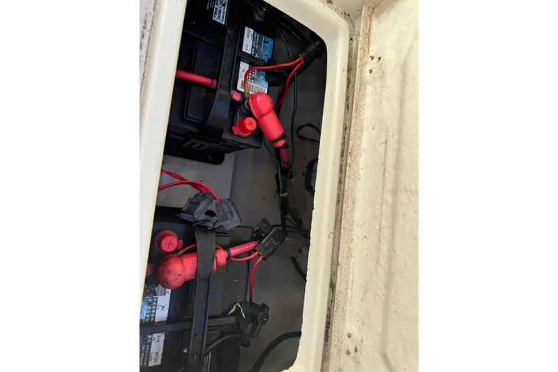 Slide: The Image of Battery compartment of a 2009 Eastern 24 boat with visible wiring connections. - 12