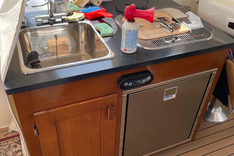 Slide: The Image of Compact kitchen area in a 2009 Eastern 248 Explorer boat with sink and stove. - 4