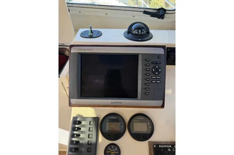 Slide: The Image of Boat dashboard with Garmin GPSmap 4208, compass, and Honda gauges, Eastern 24, 2009 model. - 6
