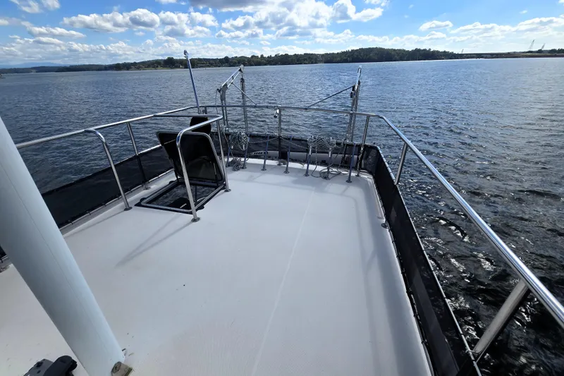 Slide: The Image of Flybridge of 2000 Nordic Tug 42, overlooking serene waters and distant shoreline. - 15