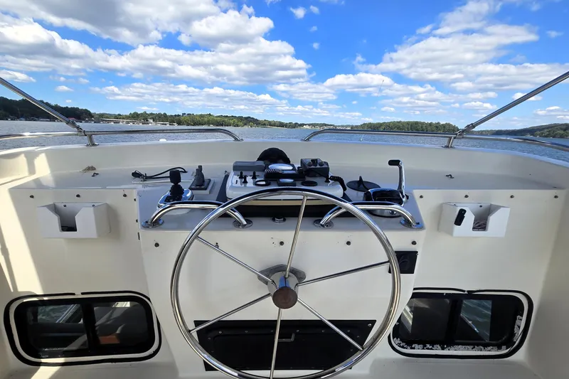Slide: The Image of Helm of 2000 Nordic Tug 42 Flybridge with scenic water view. - 16