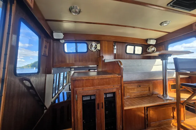 Slide: The Image of Interior of 2000 Nordic Tug 42 Flybridge with wood finish and seating area. - 22