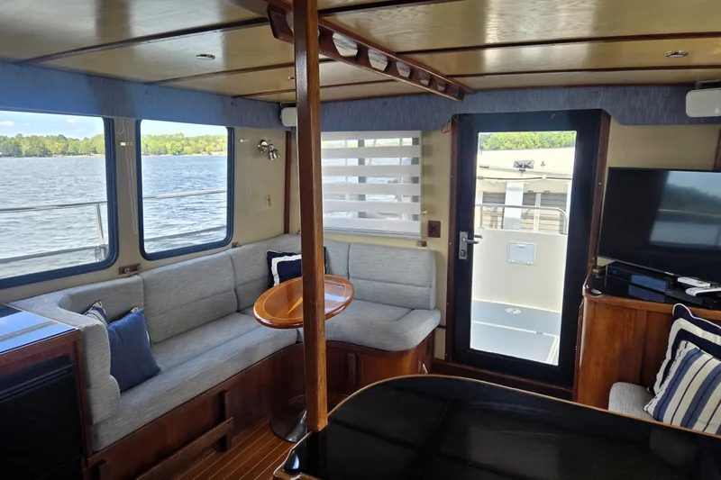 Slide: The Image of Interior of 2000 Nordic Tug 42 Flybridge with cozy seating and lake view. - 23