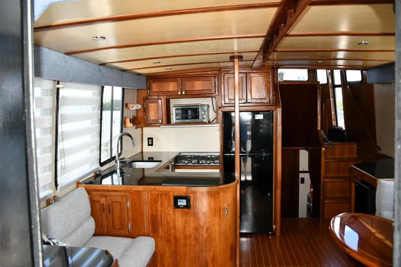 Slide: The Image of Interior of 2000 Nordic Tug 42 Flybridge with wood cabinetry and modern kitchen amenities. - 26