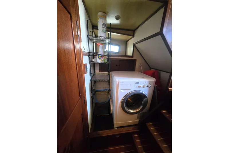 Slide: The Image of Laundry area with washing machine and shelves in 2000 Nordic Tug 42 Flybridge. - 34