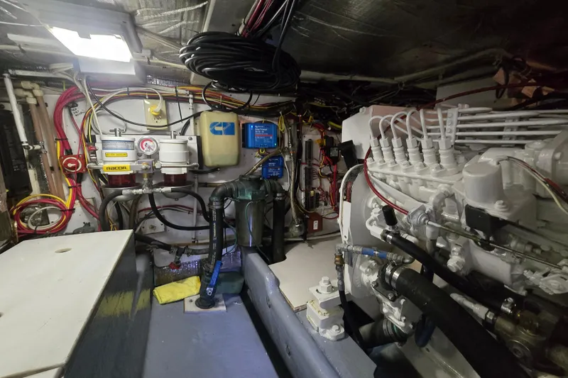 Slide: The Image of Engine room of a 2000 Nordic Tug 42 Flybridge, showcasing mechanical components and wiring. - 35