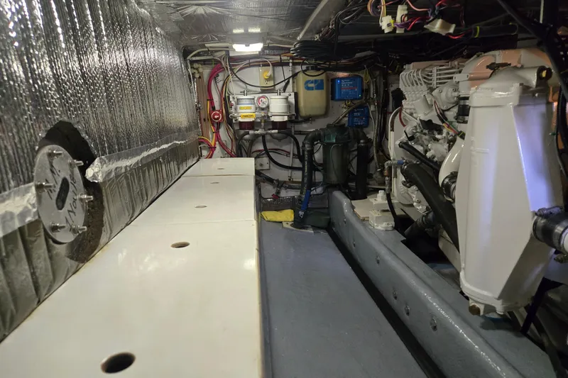 Slide: The Image of Engine room of a 2000 Nordic Tug 42 Flybridge with visible machinery and wiring. - 40