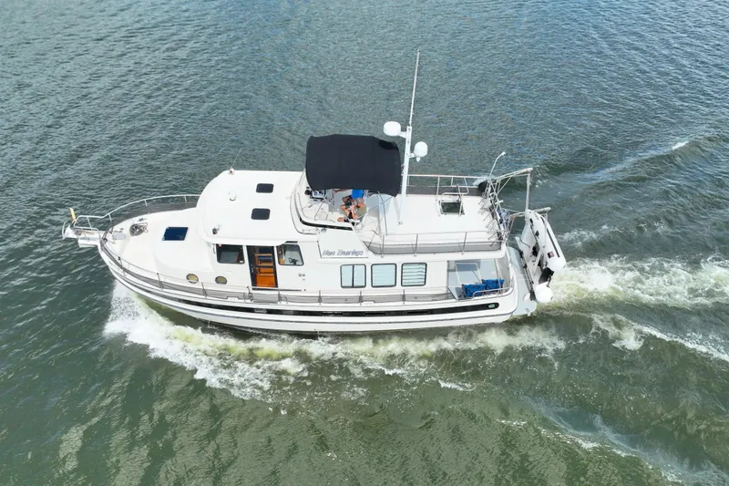 Slide: The Image of 2000 Nordic Tug 42 Flybridge cruising on open water, aerial view. - 7