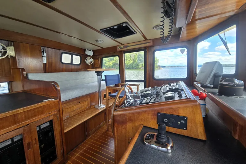 Slide: The Image of Interior of 2000 Nordic Tug 42 Flybridge with wooden helm and scenic water view. - 17