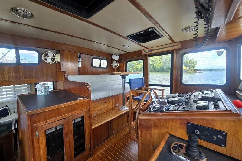 Slide: The Image of Interior of 2000 Nordic Tug 42 Flybridge with wooden finish and scenic water view. - 18