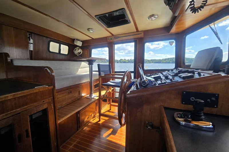 Slide: The Image of Interior of 2000 Nordic Tug 42 Flybridge with wooden helm and seating area. - 19