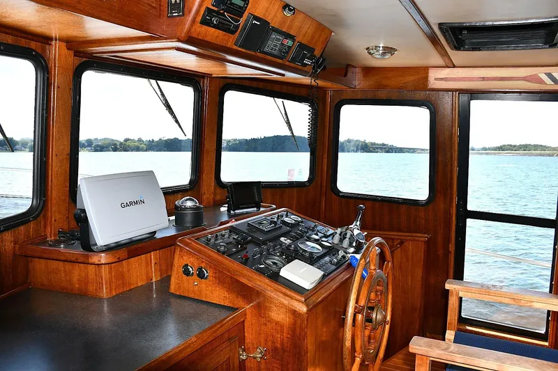 Slide: The Image of Pilothouse of 2000 Nordic Tug 42 Flybridge with Garmin navigation system, overlooking serene waters. - 21