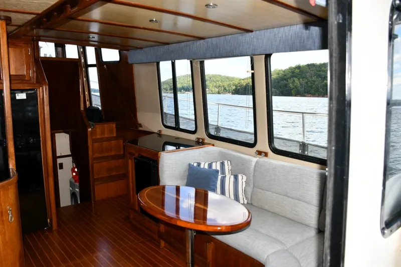 Slide: The Image of Interior of 2000 Nordic Tug 42 Flybridge with cozy seating and scenic water view. - 24