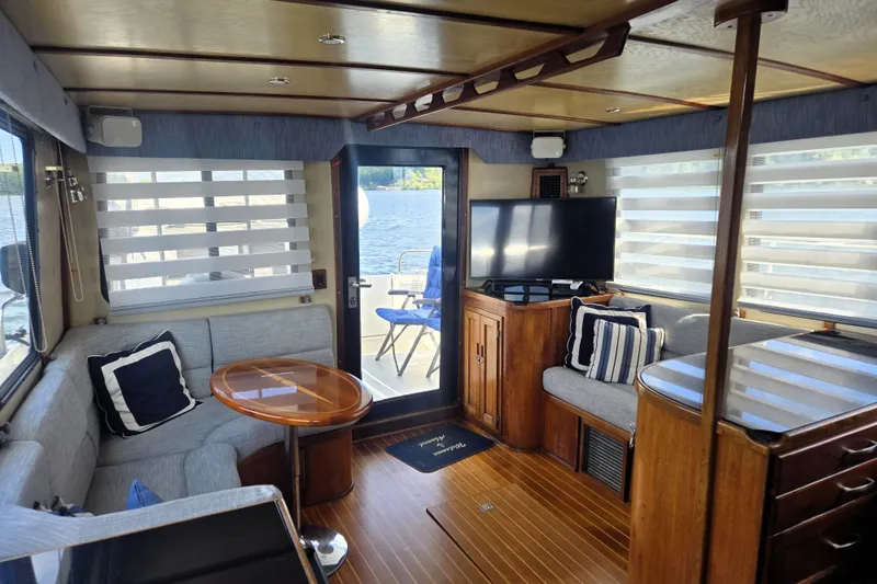 Slide: The Image of Cozy interior of 2000 Nordic Tug 42 Flybridge with seating, table, and TV. - 25