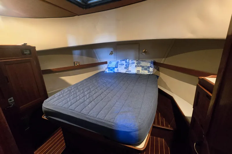 Slide: The Image of Cozy cabin interior of 2000 Nordic Tug 42 Flybridge with comfortable bed and wooden accents. - 28