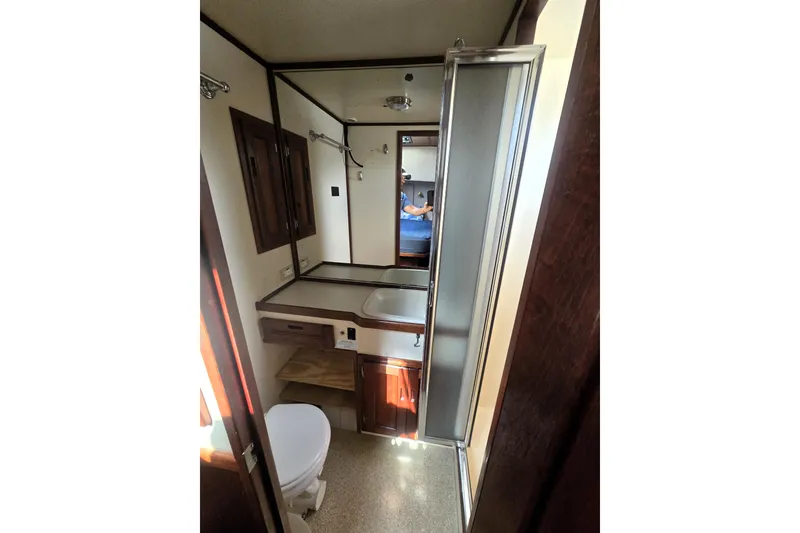Slide: The Image of Bathroom interior of 2000 Nordic Tug 42 Flybridge with shower and wooden cabinetry. - 29