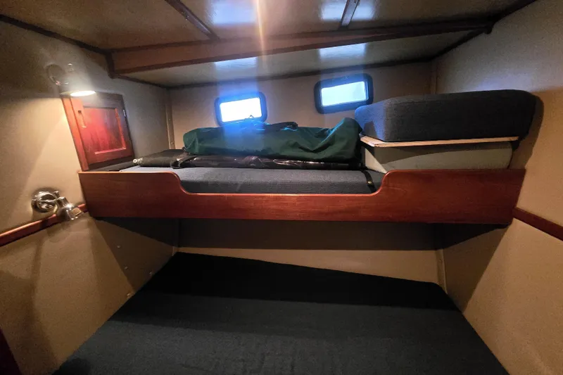 Slide: The Image of Cozy cabin interior of 2000 Nordic Tug 42 Flybridge with bunk beds and porthole windows. - 31