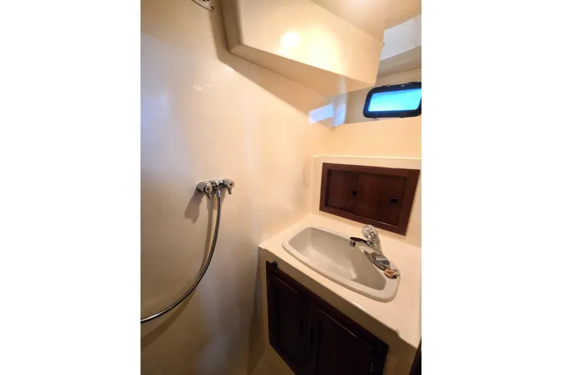 Slide: The Image of Bathroom interior of 2000 Nordic Tug 42 Flybridge with sink and showerhead. - 33