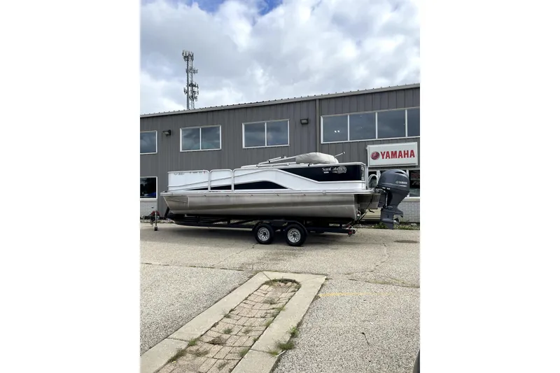 Slide: The Image of 2019 G3 SunCatcher V22 pontoon boat on trailer outside Yamaha dealership. - 1