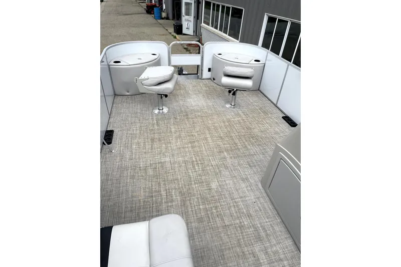 Slide: The Image of 2019 G3 SunCatcher V22 boat interior with swivel seats and spacious deck. - 11