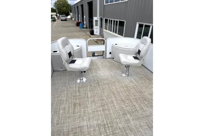 Slide: The Image of 2019 G3 SunCatcher V22 boat interior with two swivel seats on textured flooring. - 12