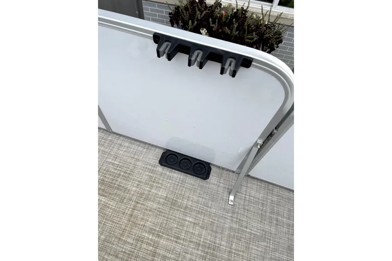 Slide: The Image of 2019 G3 SunCatcher V22 boat interior with rod holders and textured flooring. - 15