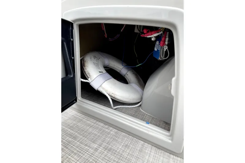 Slide: The Image of Storage compartment of 2019 G3 SunCatcher V22 with life preserver and wiring. - 16