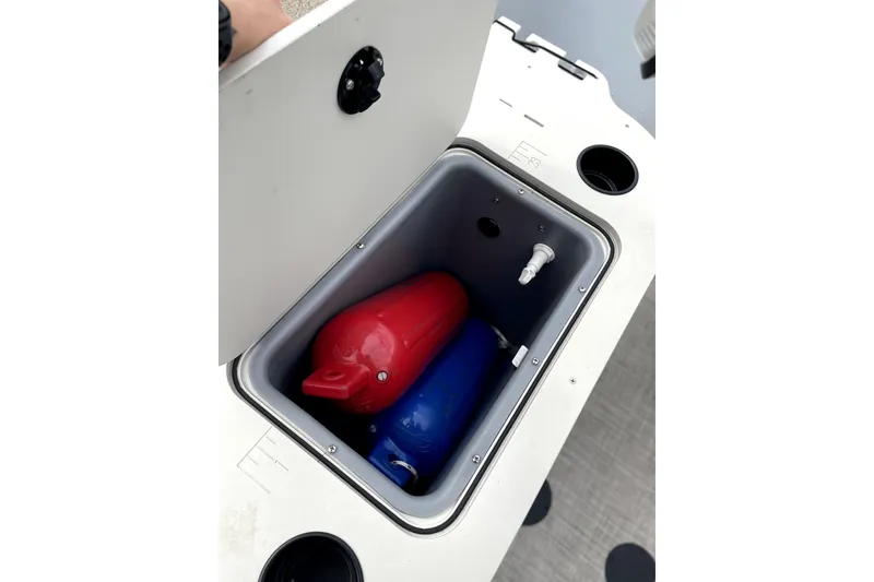 Slide: The Image of Storage compartment on 2019 G3 SunCatcher V22 boat with red and blue fenders. - 6
