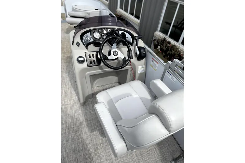 Slide: The Image of 2019 G3 SunCatcher V22 boat helm with steering wheel and controls. - 9