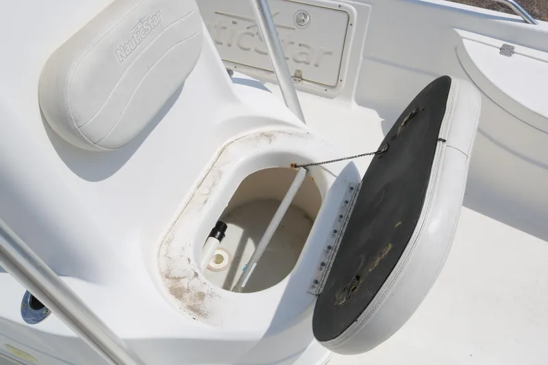 Slide: The Image of 2005 NauticStar 2200 Nautic Bay boat seat with open storage compartment. - 20